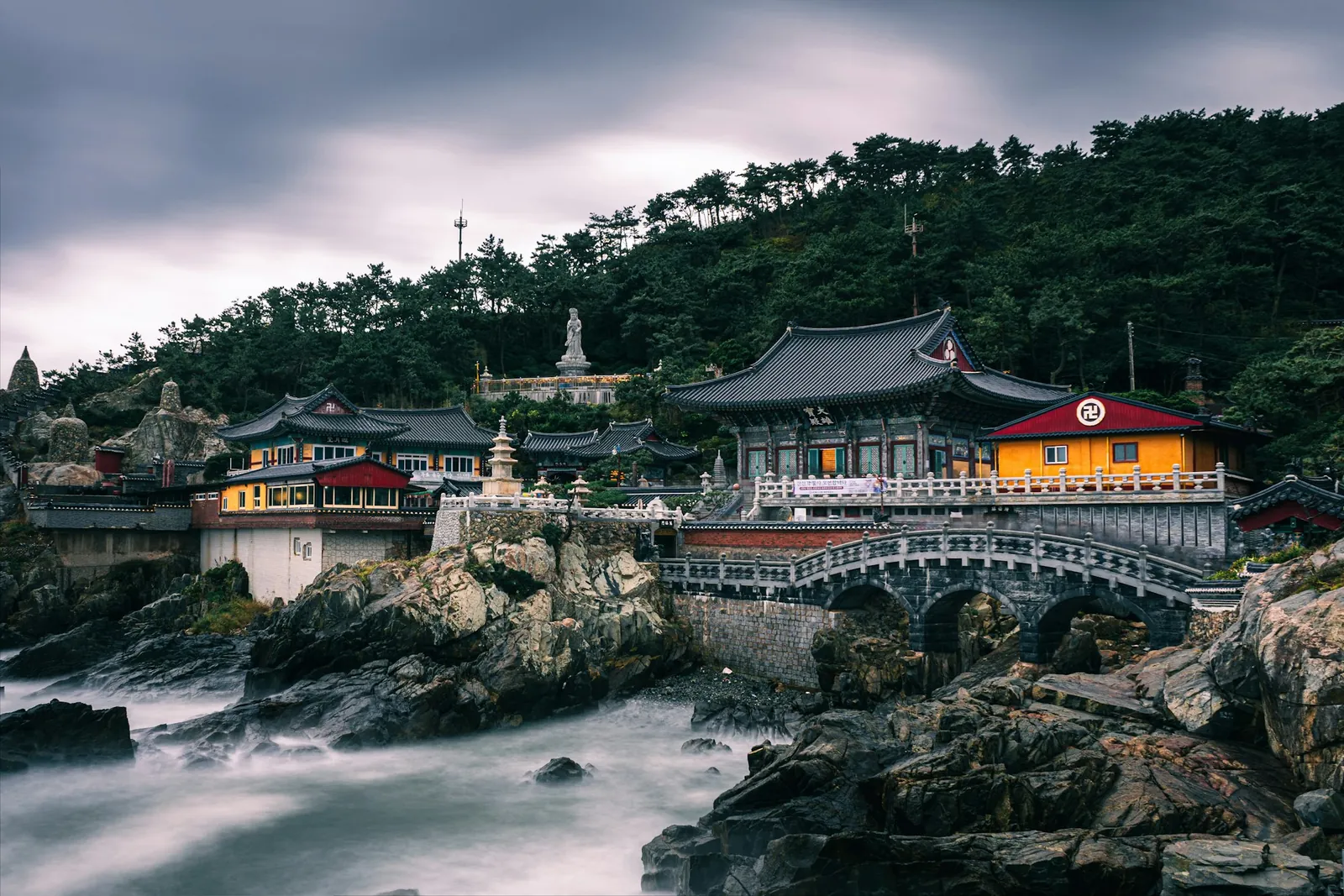 Haedong Yonggungsa temple built into the rocky coastline above the sea near Busan.