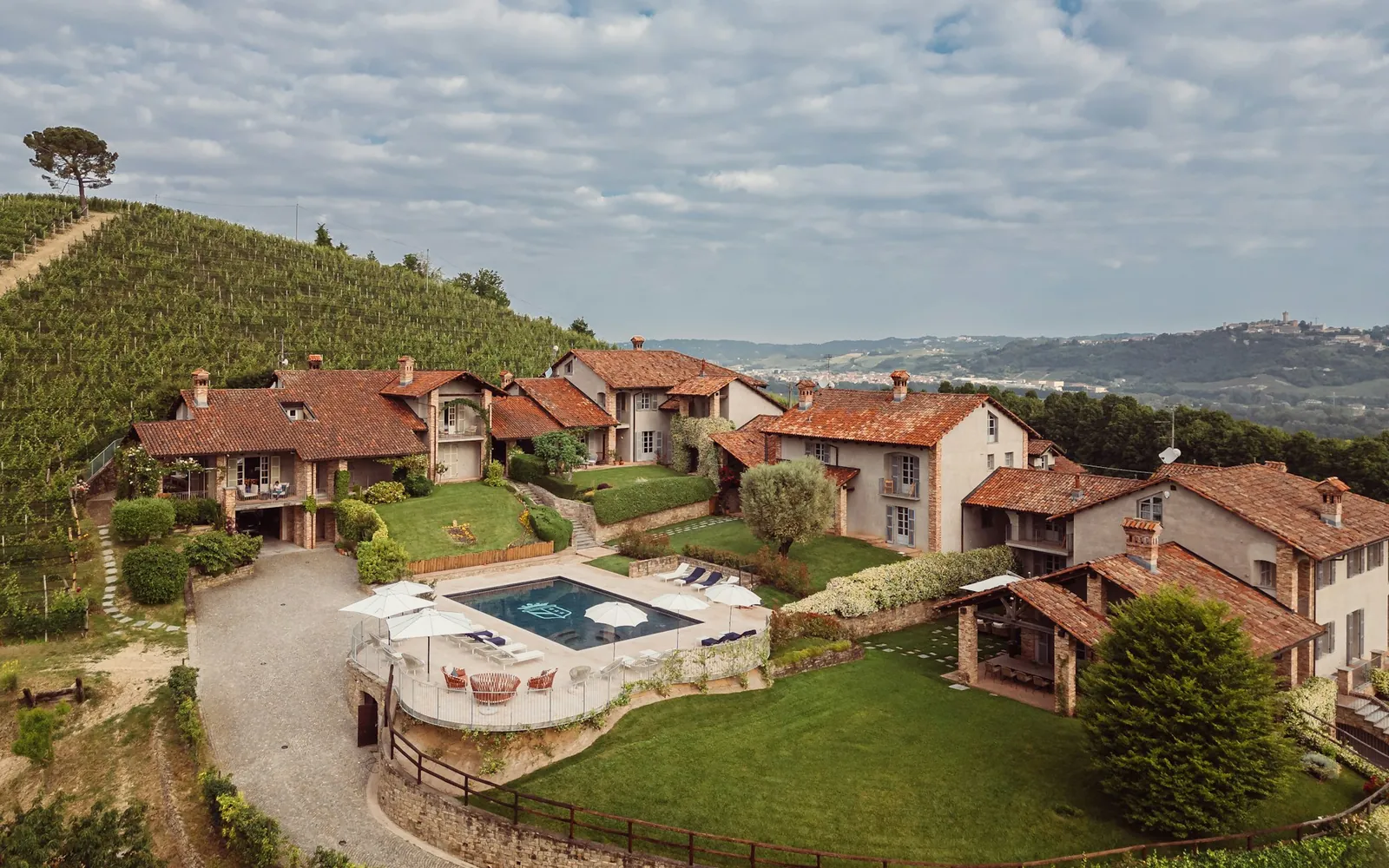 A private stone estate with a pool, set among terraced vineyard hills.